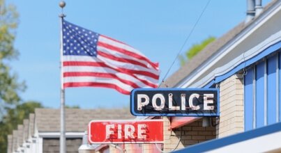 Fire and Police signs in front of the American Flag